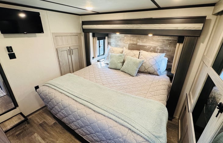 View or master bedroom from the closet with Roku TV.