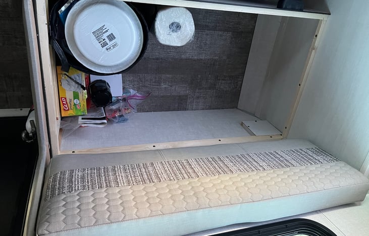 One bench has storage underneath for supplies. The other bench does not as it houses the furnace for the heater.