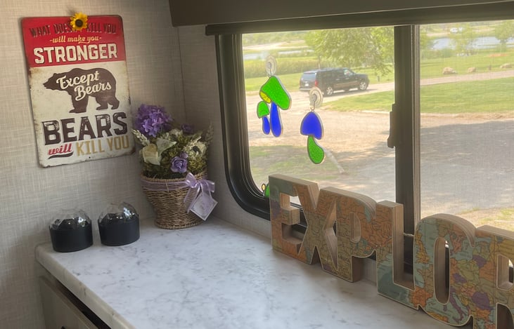 When we deliver the 5th wheel Impression to you, Della loves to put up the Home Decor to make it feel like a cozy home. this trailer has a theme of bears, bees, and bigfoot!! LOL!