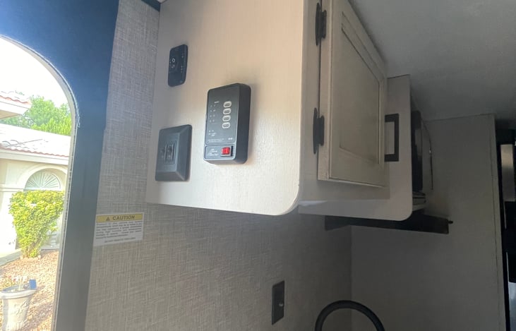 Awning switch, gray and black water tanks check panel.