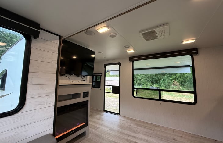 Lovely picture window next to the cozy fireplace
