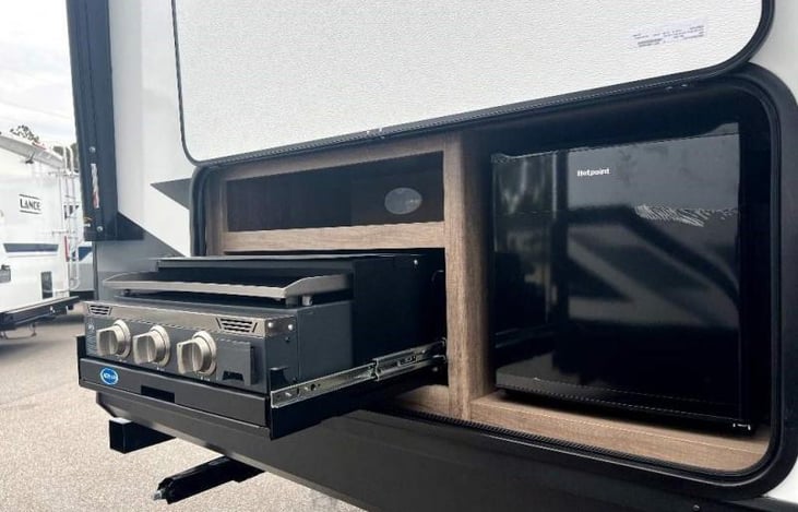 Outdoor kitchen stove and mini refrigerator