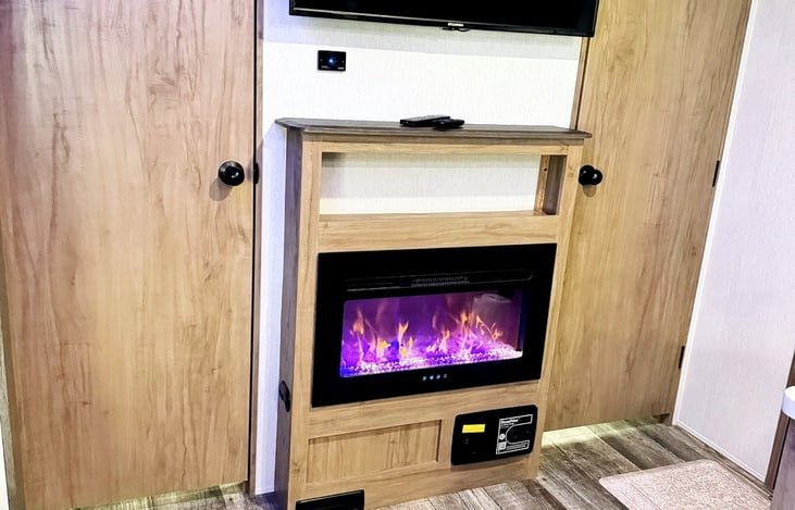 Electric fireplace and smart TV create a cozy home-away-from-home experience.