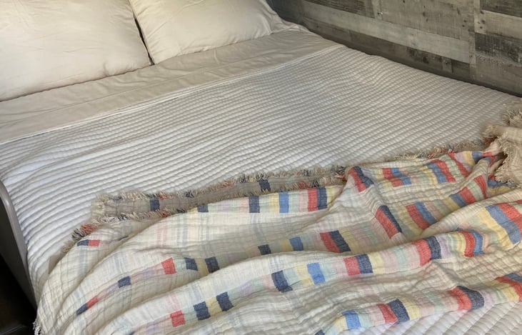 Queen size bed with memory foam mattress topper. Storage area under bed.