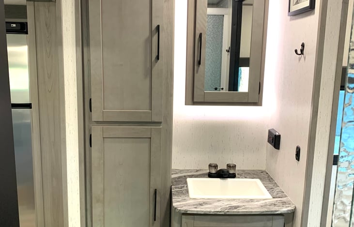 First Aid Kit, Hand Soap, RV Safe Toilet Paper, Bathmat, and Towels are provided.