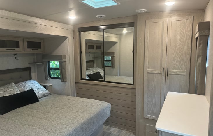 Large mirrored closet with hangers provided. Dresser and two large drawers at the end of the bed. Linens, pillows blankets and beach towels in large storage closet.