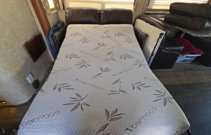 Full size memory foam retractable love seat with levelers also pictured table if you would like to rent and large pet crate.