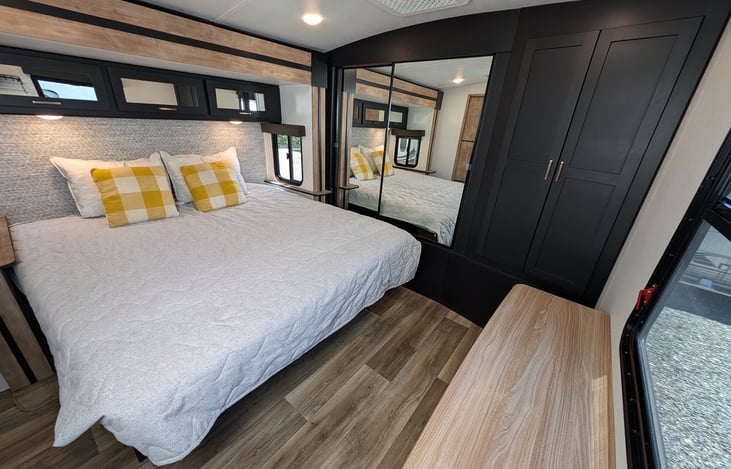 Comfy King bed with ample storage in the bedroom.