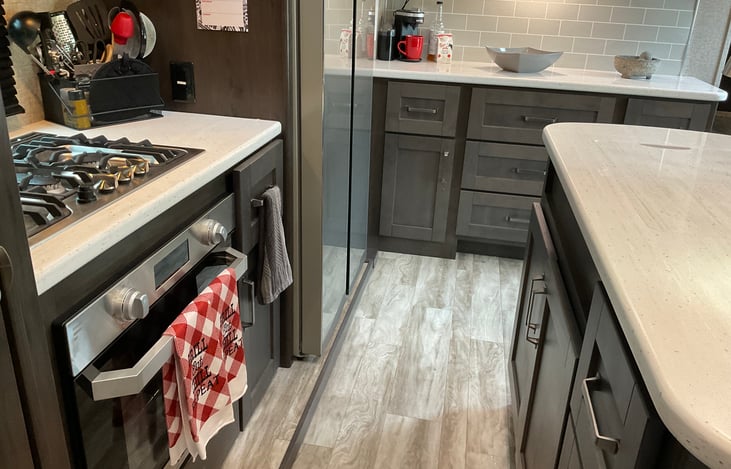 Kitchen is equipped with a 3 burner stove and oven