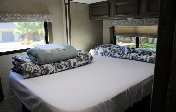 The queen bed slide-out allows for easy access on both sides of the bed. Two large windows for dramatic views and an upgraded custom-made memory foam mattress. Bedding for two people included.