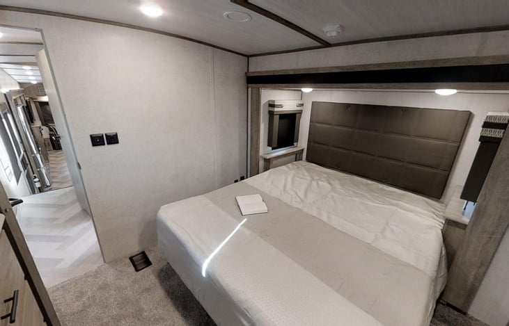 Queen size master bedroom with smart TV.