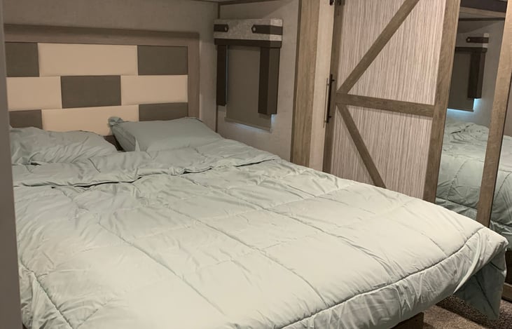 Main bedroom with king size bed and sliding closet doors.