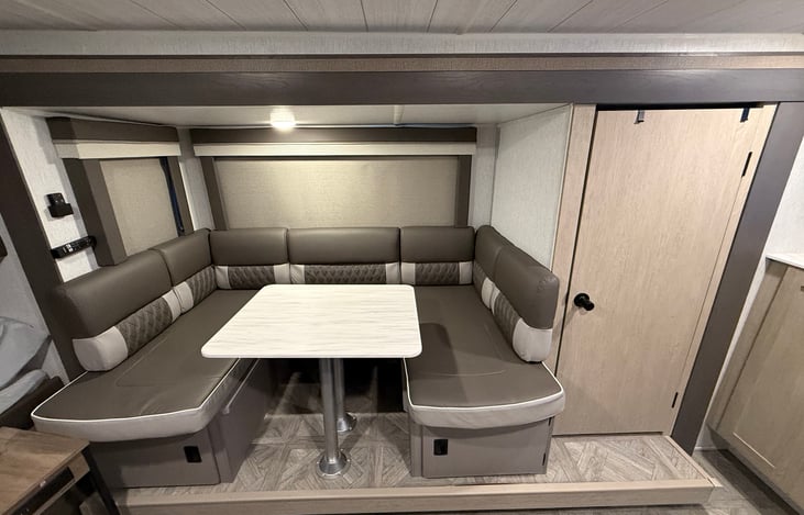 U-shaped dinette seats the whole family and converts to a bed