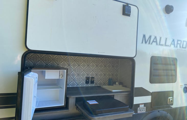 Party center while it's open. You have a mini fridge, sink, outlets and an outdoor burner.