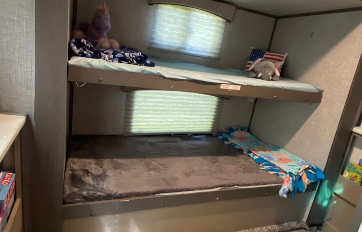 Back bump out with two bunkbeds and a half bath. Great storage under the bottom bunk helps keep the room more organized. Side shelves are filled with coloring materials, kids books and a few games too