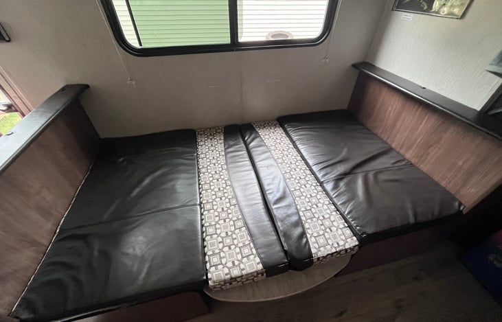 Dinette converted to small bed for sleeping
