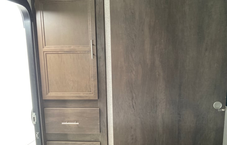 The front bedroom has a door that can be closed. It also has three small closets, two drawers, and a separate entry.