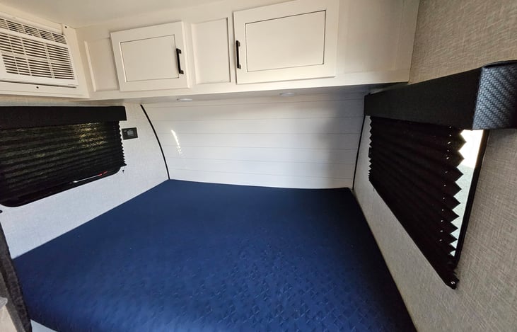 Queen size bed with privacy curtain.