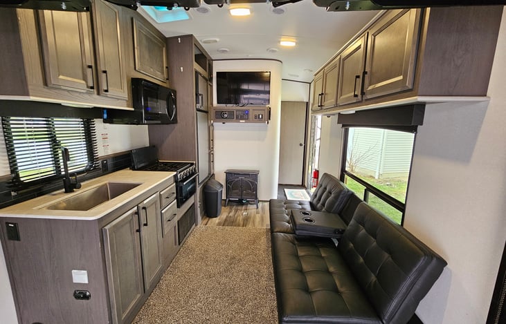 Living/Kitchen space comes complete with a Futon, 3 Burner range, Oven, Microwave and refrigerator. don't forget about the TV, entertainment center and fireplace for those chilly nights!