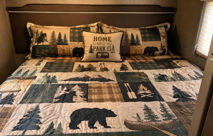 Huge bed in back, also converts to two large twin beds if needed. Decor may vary.