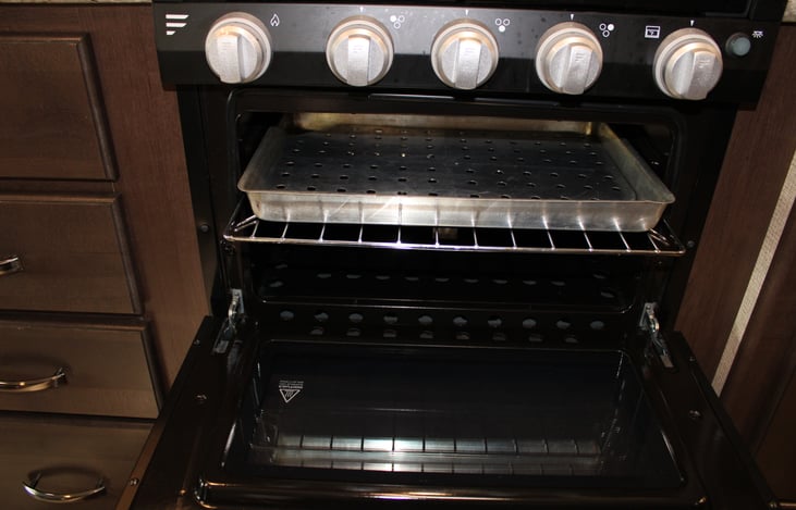 Small oven runs on propane, easily fits a pizza or bakes cookies. For easy clean up we recommend disposable aluminum baking trays.