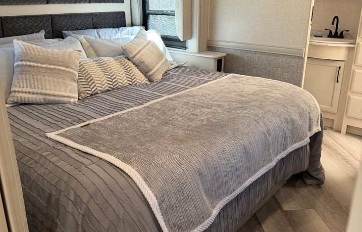 King size bed in master bedroom with door for privacy