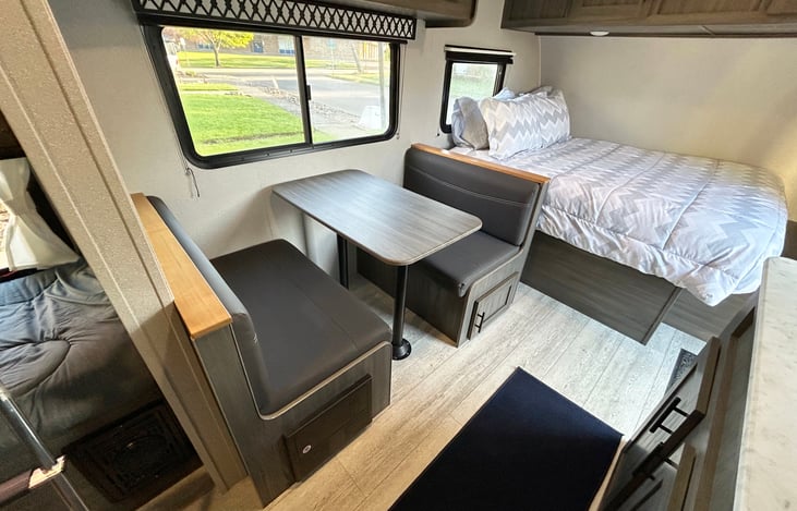 Dinette fits a family of 4 and can convert to an extra bed.