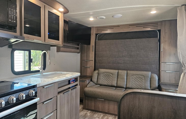 Sofa/Queen murphy bed, Smart TV on swivel mount easily viewable from dinette