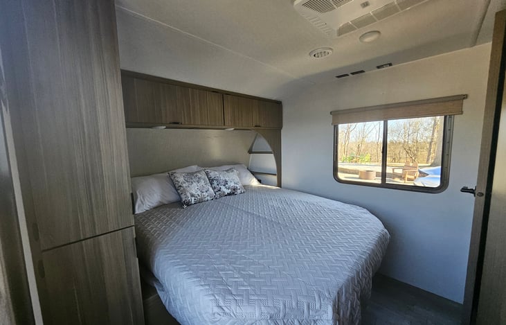 Primary bedroom with king size adjustable bed along with closet and storage