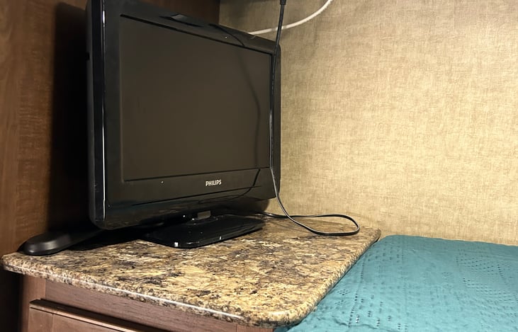 Top bunk TV with remote.