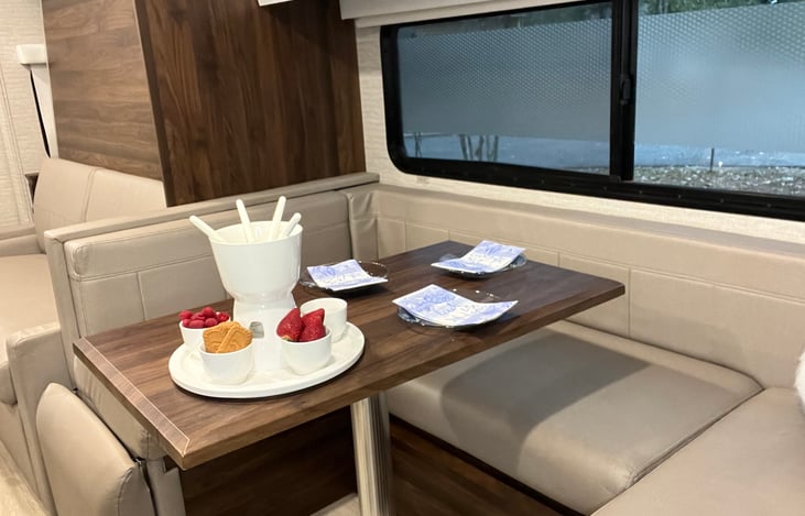 Swivel table converts to 3rd bed. Storage under seats and overhead.