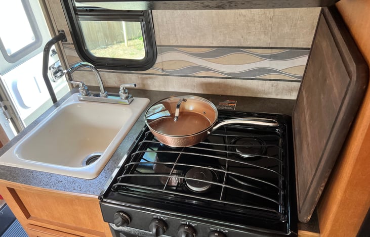 Closer view of the stove/sink area.