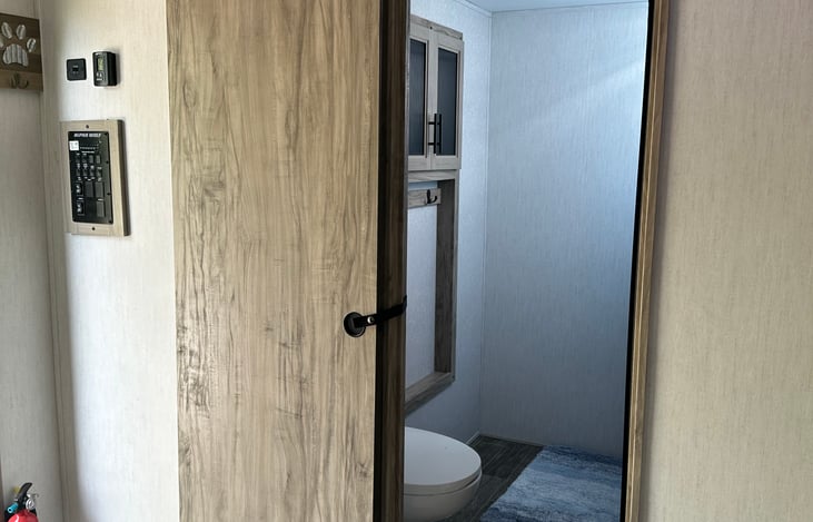 Spacious bathroom with shower and ample storage.