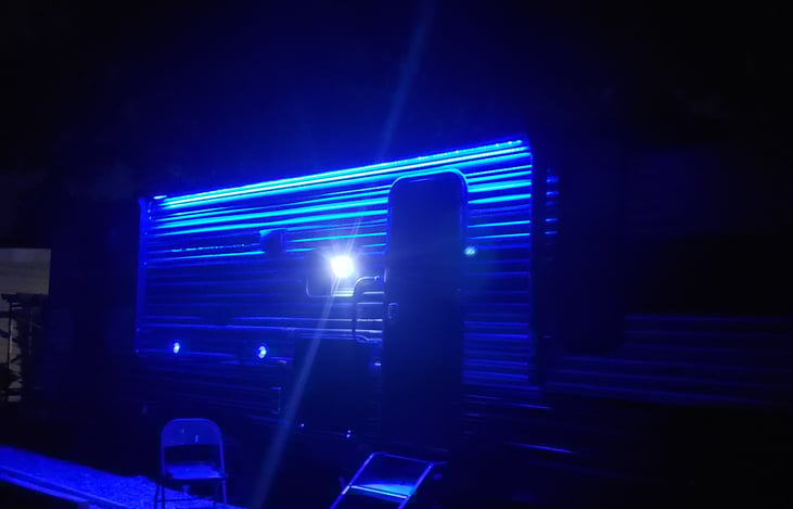 Blue accent light outside under awning.