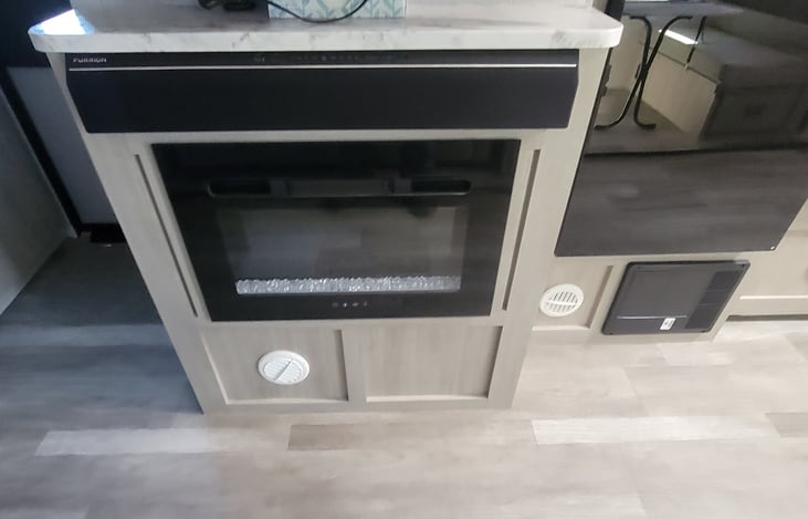 Electric fire place that works as an electric heater that will heat the entire camper on those cool fall evenings.