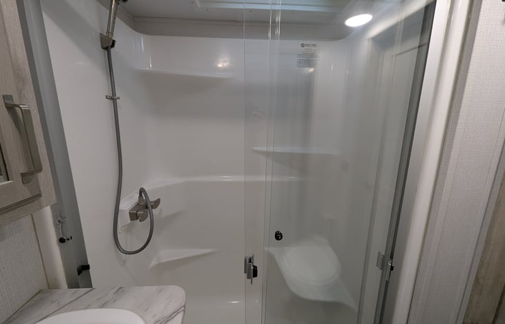 Experience a spa-like retreat with a walk-in shower, porcelain toilet, and spacious vanity. Large medicine cabinets provide ample storage, making this private master ensuite a true luxury upgrade.