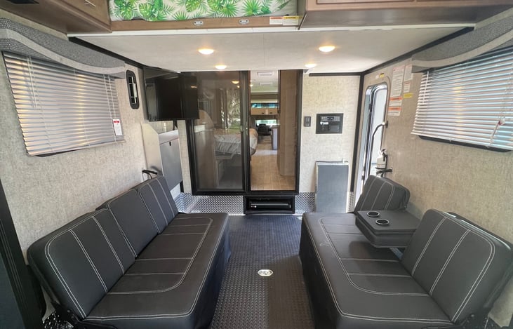 2 sofas and a TV in the toy hauler garage .