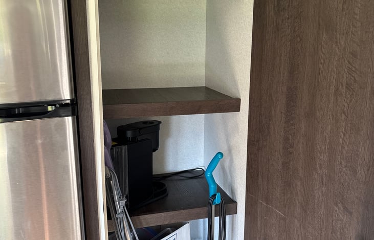 Pantry with paper products, keurig, toaster, and some storage and cleaning items