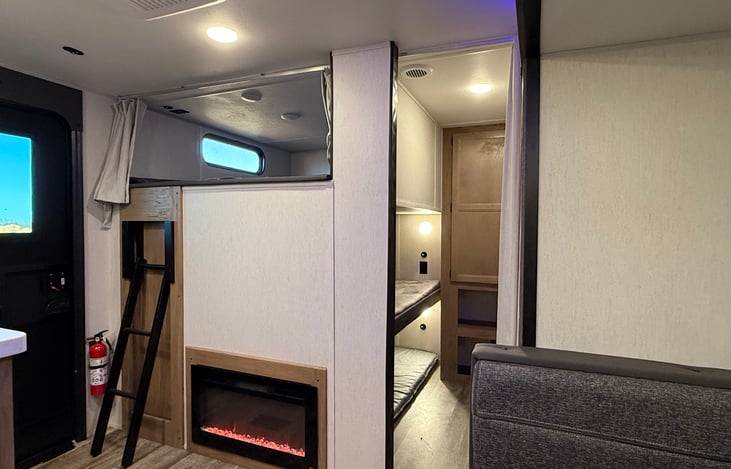 Bunk City!  One double up top with curtains and two singles below with a closet and curtain for privacy