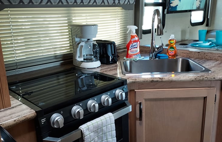 Kitchen equipped with cleaning products.