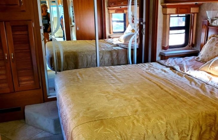 Queen size bed with sizeable closet and walk around bed.