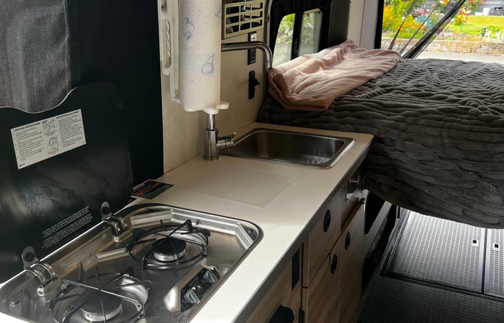 2 burner propane stove and kitchen sink.