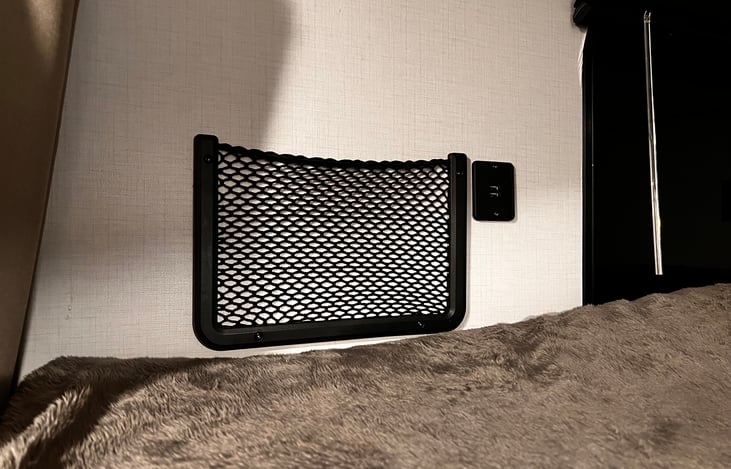 Storage wall baskets in Bunk area with USB wall charging ports.