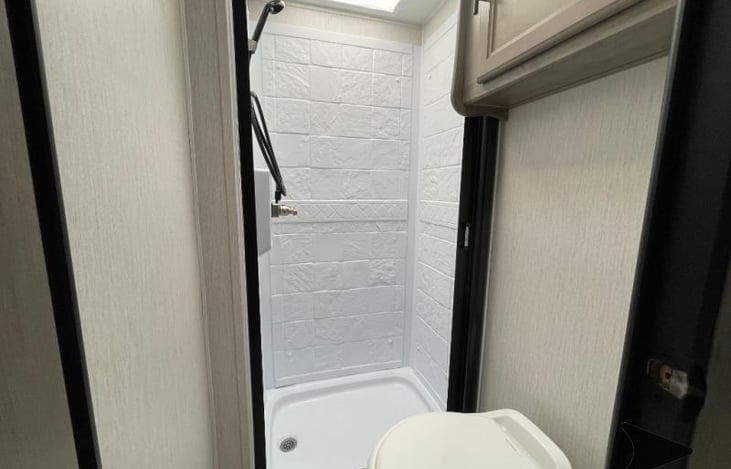 Shower with a telescopic shower curtain, so you don't have to fight that pesky curtain clinging to your body.