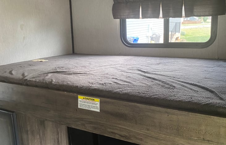 Wide bed - upper bunk- above the entertainment center in back room