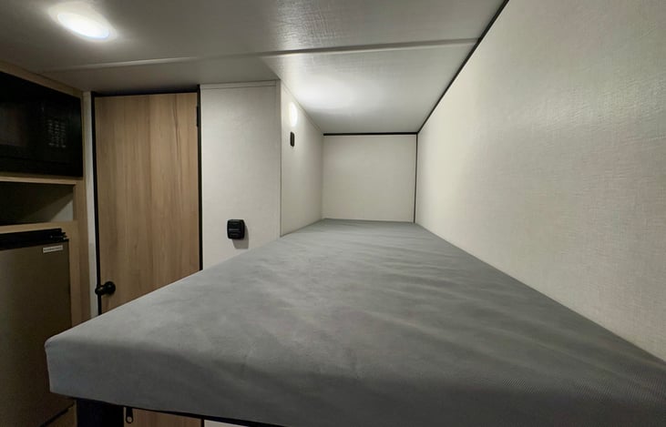 Top bunk with light and outlet.