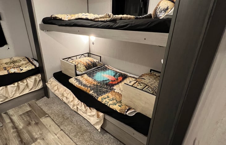 Bedroom with 2 end table, with some storage pockets to hold socks, shoes, phones, important things to not leave behind etc