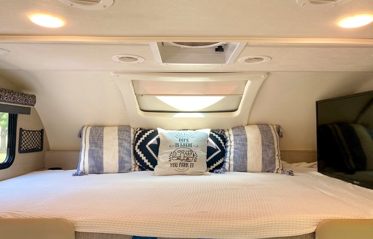 Top bunk can fit two smaller people if need be. 2 cup holders and side pockets for storage up top. Flat screen TV. Decor pillows can stay with RV if desired.