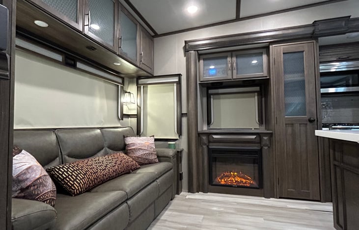 Living room and fireplace. Electric insert can give heat and/or the fire ambiance as needed.