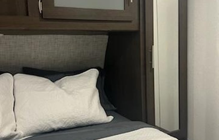 Master bedroom number 1. Stroage bins under bed for extra storage.  5 hangers in closet area. Window that opens with screen.